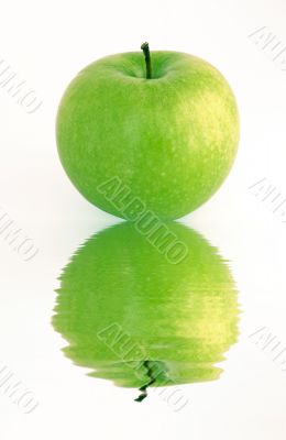 green apple reflecting in a water