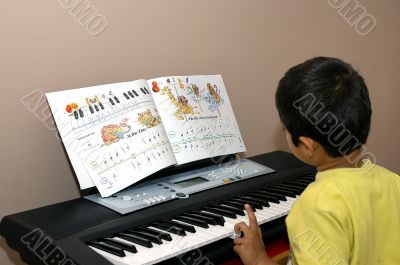 kid practicing piano