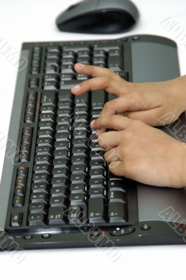 Hands typing on a computer key board