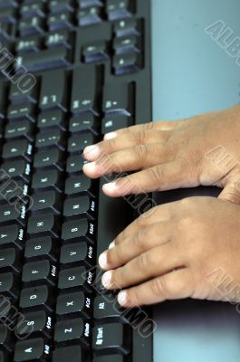 Hands typing on a computer key board