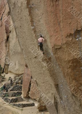 Climber on overhanging cliff