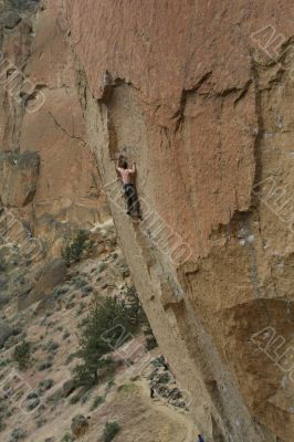 Climber on overhanging cliff