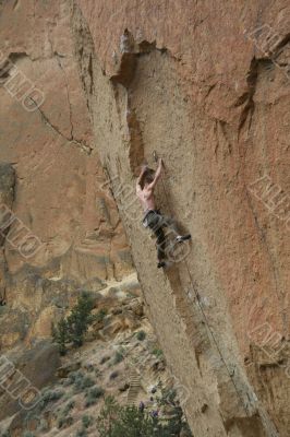 Climber on overhanging cliff