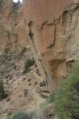 Climber on overhanging cliff