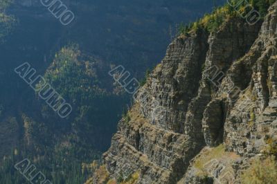 Steep layered cliff and forest valley