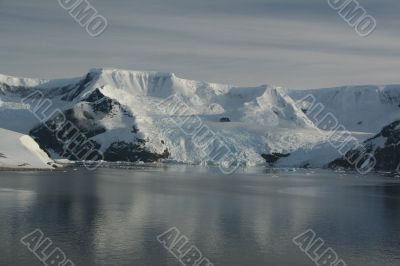 Mountains & glaciers reflected in calm ocean Mountains & glaciers reflected in calm ocean