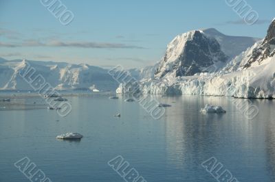 Mountains &amp; glaciers reflected in calm ocean