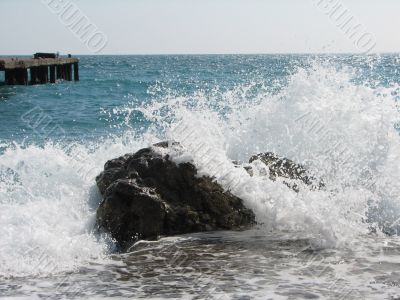 cold sea waves crashing against the coast stone