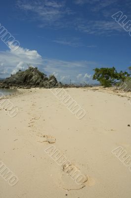 footprints in the sand of deserted island
