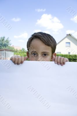 Boy keeps sheet of paper