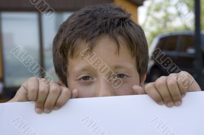 Boy keeps sheet of paper