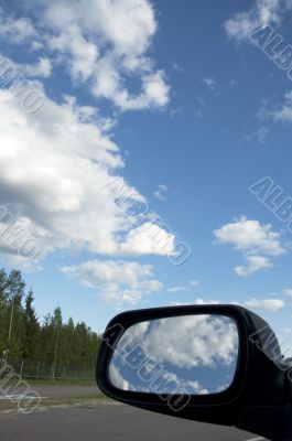 sky reflecting in rear view mirror