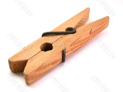 wooden clothes peg on a white background