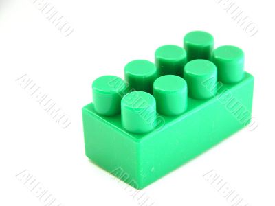 the green on white plastic toy building block