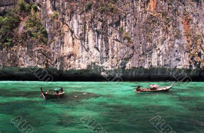 longtail boats in turquoise waters
