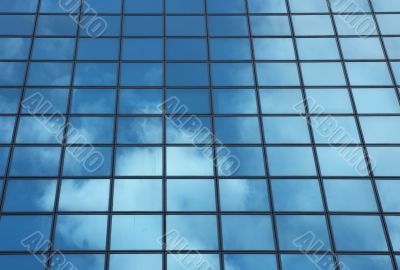 sky reflecting in windows of office building