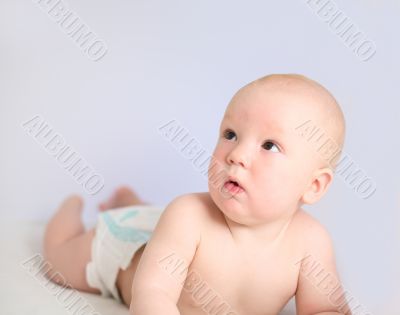 Funny little baby on grey