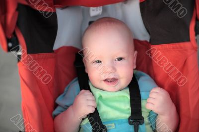 Baby sitting in stroller. Close-up #1