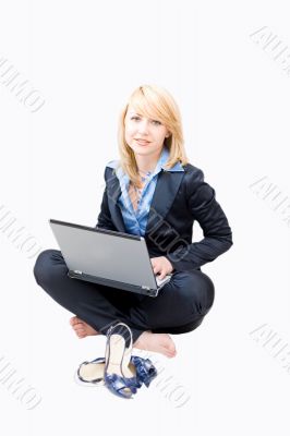 Woman working on a laptop and take off shoes