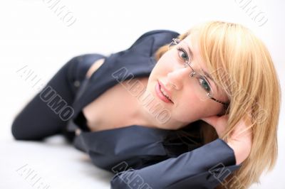 Pretty girl in formal dress lying on bed #1