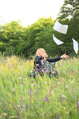 Businesswoman on nature catch documents