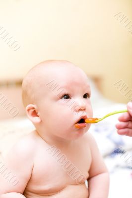 Baby eating by plastic spoon Baby eating by plastic spoon
