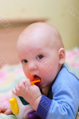 Baby put toy in mouth