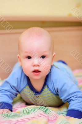 Surprised baby on bed