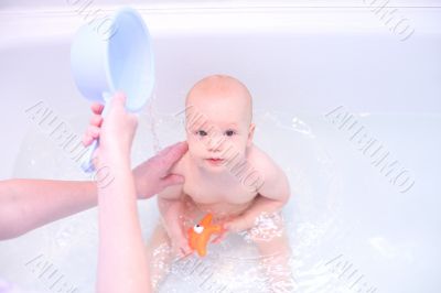 Baby in bath with toys