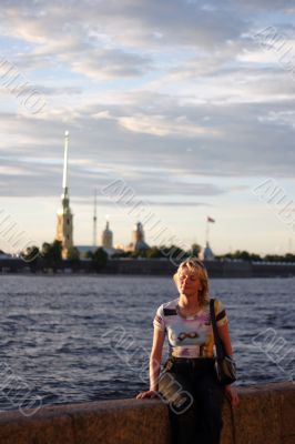 Girl sitting on canal border in Saint Petersburg