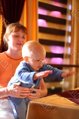 Mother holding enjoying baby slaping by hands Mother holding enjoying baby slaping by hands