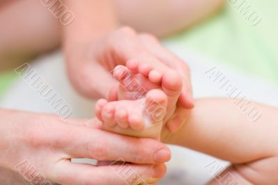 Mother hold baby leg together in your hand l#3