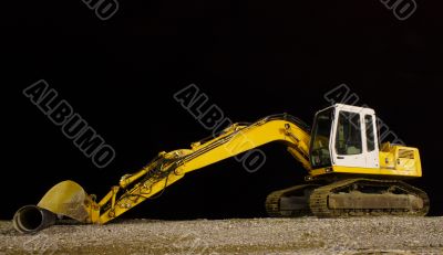 excavator on night pebble beach mounting tube