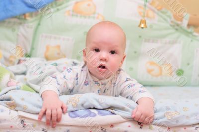 Baby rest on bed and look at camera #1