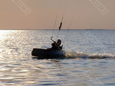 Silhouettes kitesurf on a gulf on a sunset 2