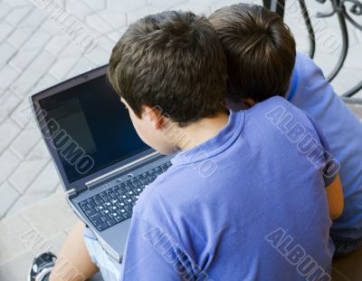 Two cute boy study on computer