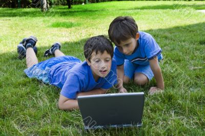 Two cute boy study on computer