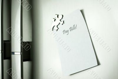 Post-it on fridge that spells pay bills Post-it on fridge that spells pay bills