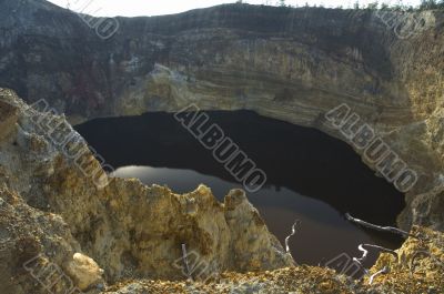 black lake in volcano crater, kelimutu, flores, indonesia
