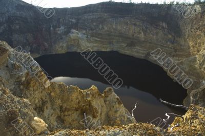 black lake in volcano crater, kelimutu, flores, indonesia black lake in volcano crater, kelimutu, flores, indonesia