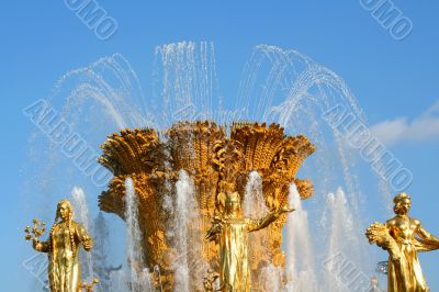 Golden fountain on blue sky