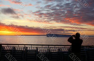 Cruise ship passengers taking pictures of sunset