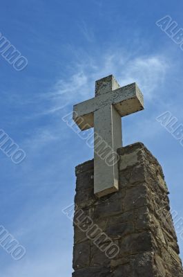stone cross over blue sky