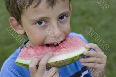 Boy eats watermelon