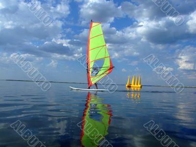Windsurfer and its reflection in water of a gulf