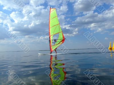 Windsurfer and its reflection in water of a gulf 2