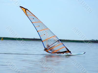 windsurfer on waves of a gulf in the afternoon