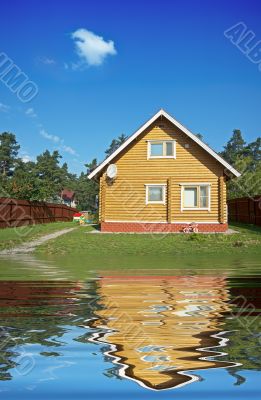 wooden house reflecting in the water