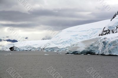 Overcast, glaciers falling into the sea