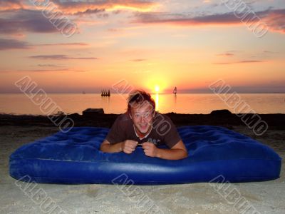 The joyful guy on a mattress